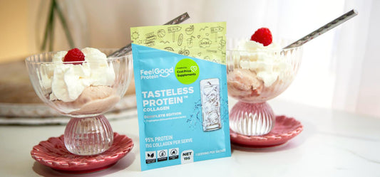 Front-facing photo of two glass bowls of Raspberry Swirl Protein Ice Cream with a blue and yellow sachet of Tasteless Protein Collagen by Feel Good Protein in the centre, with a softly blurred modern kitchen in the background.