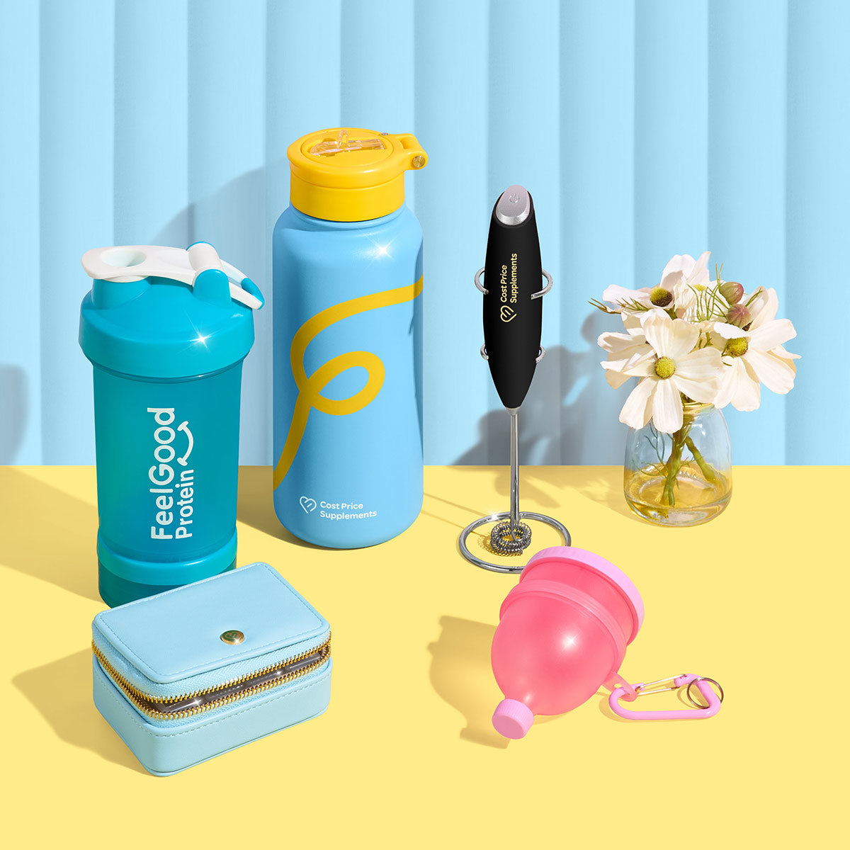 Collection of fitness and lifestyle products on a yellow surface with a blue striped background