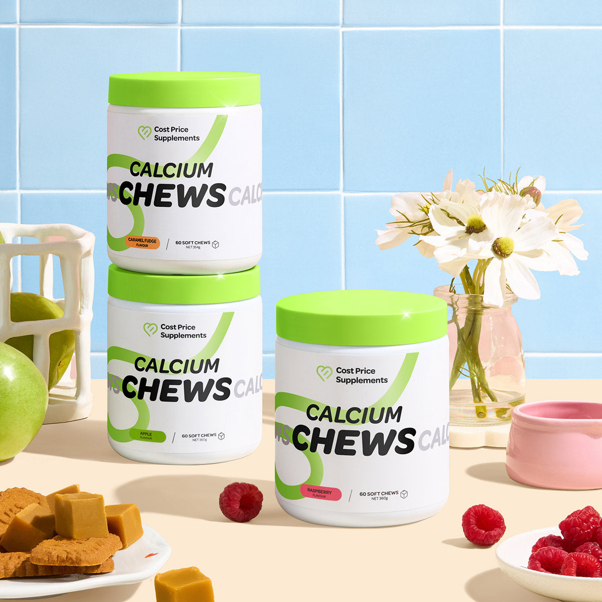 Three containers of 'Calcium Chews' on a table with fruits and flowers in the background.