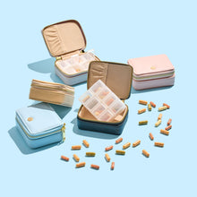 6 cost price supplements luxe pill cases in different colours on a blue background