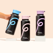 3 black water bottles with colourful swirls on a peach backgound with a person hand holding one of the water bottles