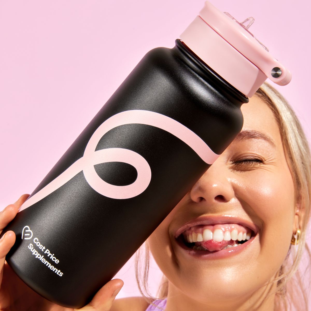 Happy Women holding a black water bottle with a pastel pink swirl