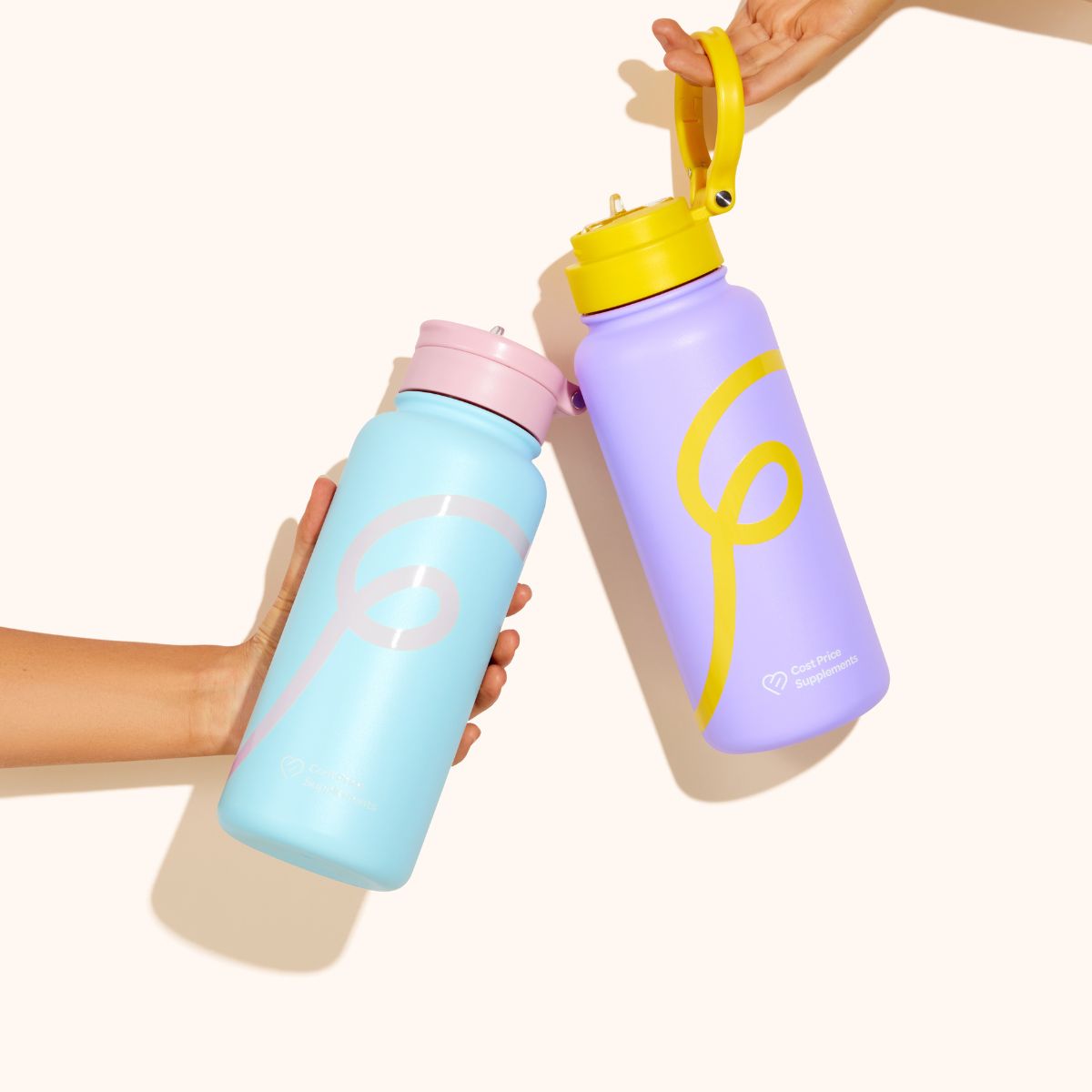 Blue and Pink Swirl water bottle and a purple and yellow swirl water bottle being held up by hands on a cream background