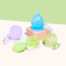 Cost Price Supplements Powder Funnels in Blue, Purple and Green on platforms in front of a green wall