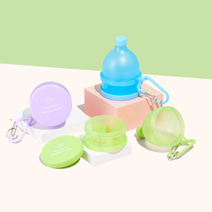 Cost Price Supplements Powder Funnels in Blue, Purple and Green on platforms in front of a green wall