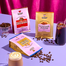 Feel Good Coffee packages with coffee beans and drinks on a purple surface