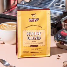 Feel Good Coffee House Blend package with a coffee cup and coffee beans in the background