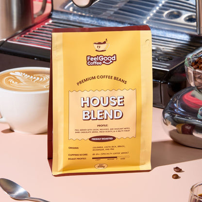 Feel Good Coffee House Blend package with a coffee cup and coffee beans in the background