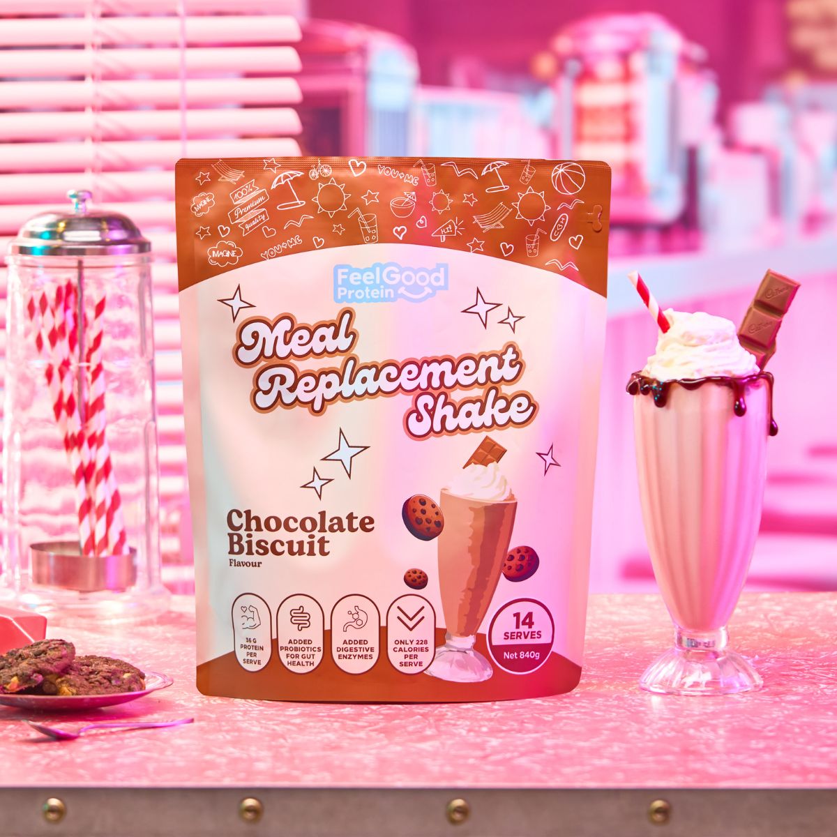 Chocolate Biscuit Meal Replacement Shake by Feel Good Protein in a retro diner next to a chocolate shake