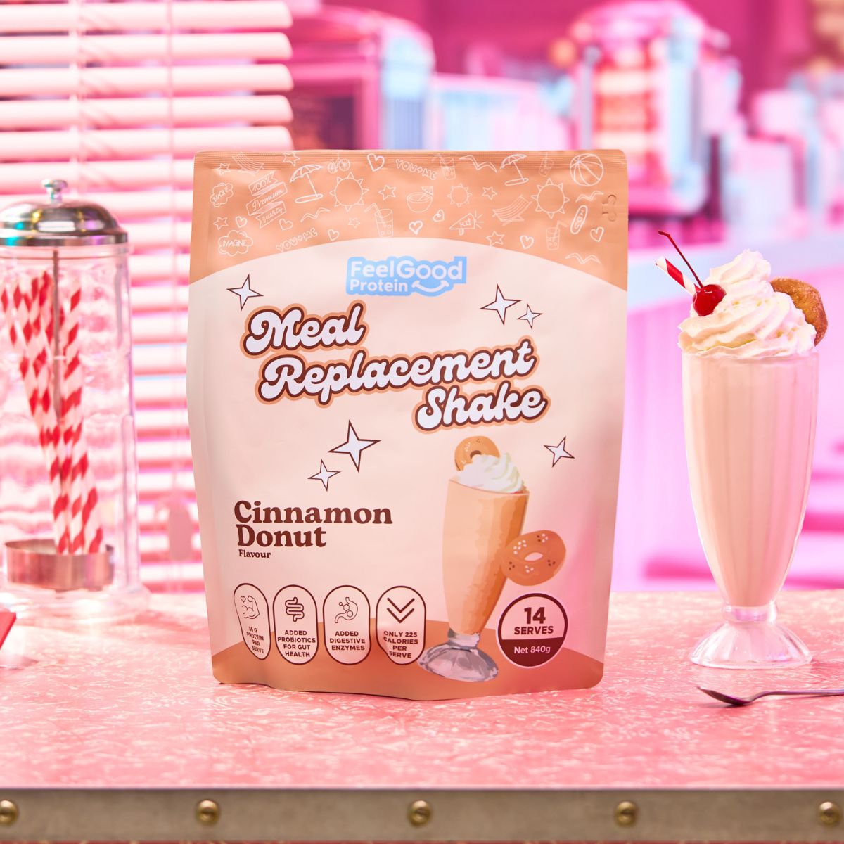 Cinnamon Donut Meal Replacement Shake by Feel Good Protein in a retro diner next to a cinnamon shake