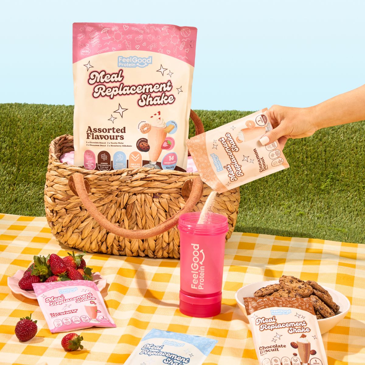 Meal Replacement Shake Assorted Flavours by Feel Good Protein in a picnic basket next to Cinnamon Donut shake being poured into a Feel Good Shaker Bottle. 