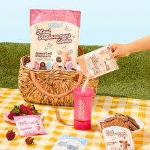 Meal Replacement Shake Assorted Flavours by Feel Good Protein in a picnic basket next to Cinnamon Donut shake being poured into a Feel Good Shaker Bottle. 