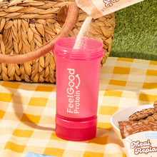 Feel Good Protein Shaker Bottle in pink on a picnic rug