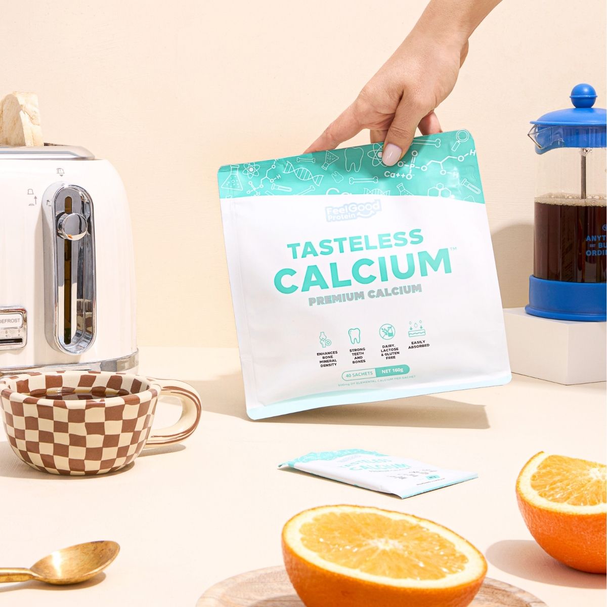 Tasteless Calcium by Feel Good Protein surrounded by breakfast, coffee, toast and oranges