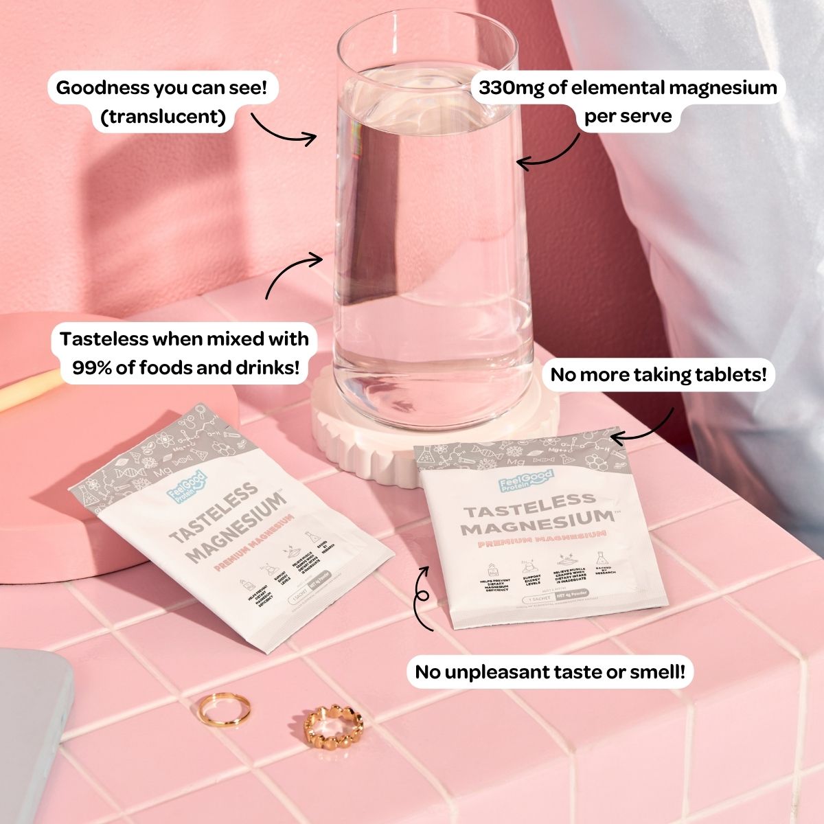 Tasteless Magnesium Sachets by Feel Good Protein on a pink, tiled bedside table next to a glass of water with callouts of product benefits
