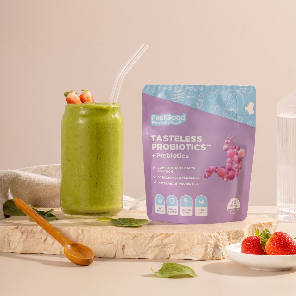 Tasteless Probiotics by Feel Good Protein next to a green smoothie