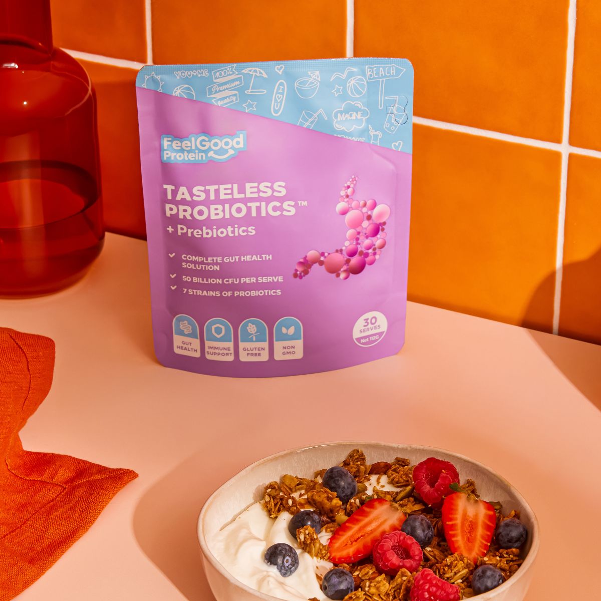 Tasteless Probiotics by Feel Good Protein next to a bowl of yoghurt with berries