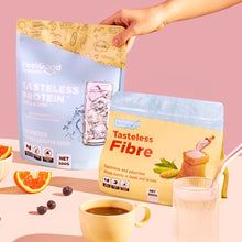 Tasteless Fibre and Tasteless Protein Bundle Pack by Feel Good Protein next to orange slices and coffee