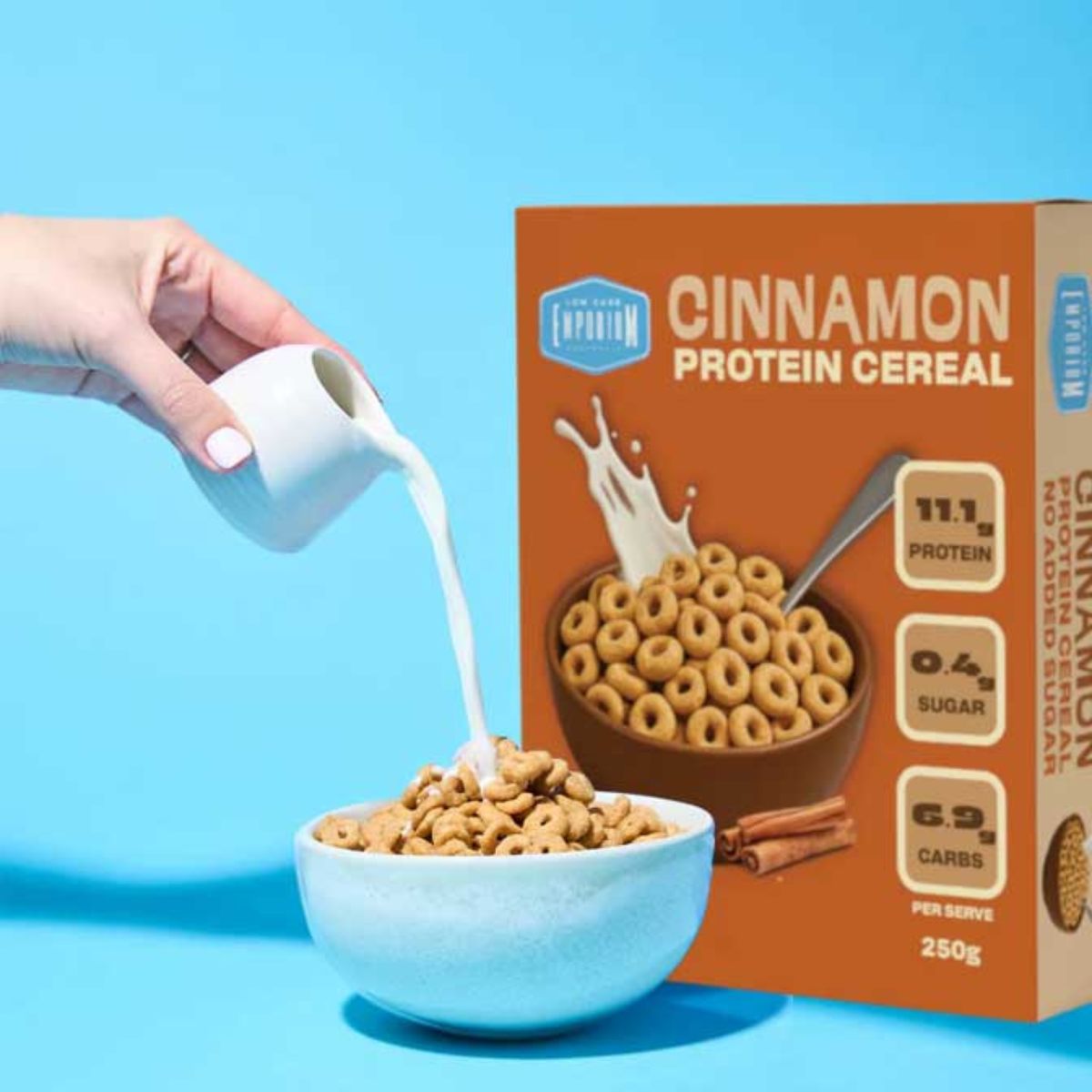 Cinnamon Protein Cereal by Low Carb Emporium next to a bowl of cereal with milk being poured in