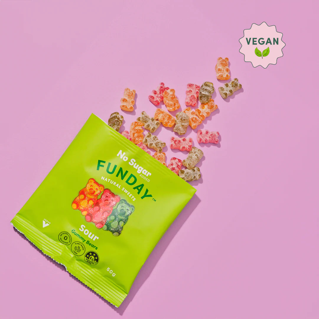 Green package of 'No Sugar Funday' gummy bears on a pink background with scattered gummies.