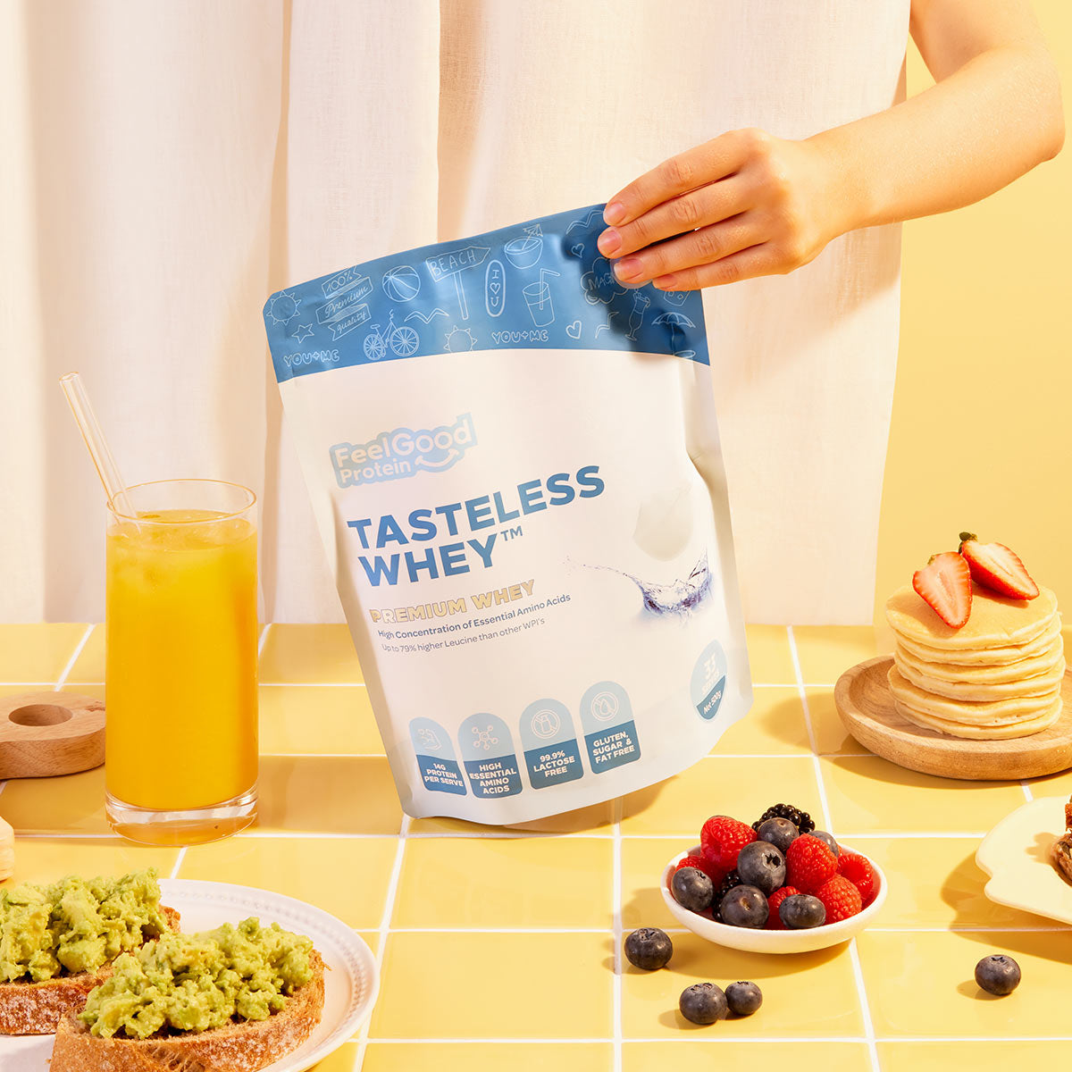 Bag of Tasteless Whey protein powder on a table with food items and a glass of juice.