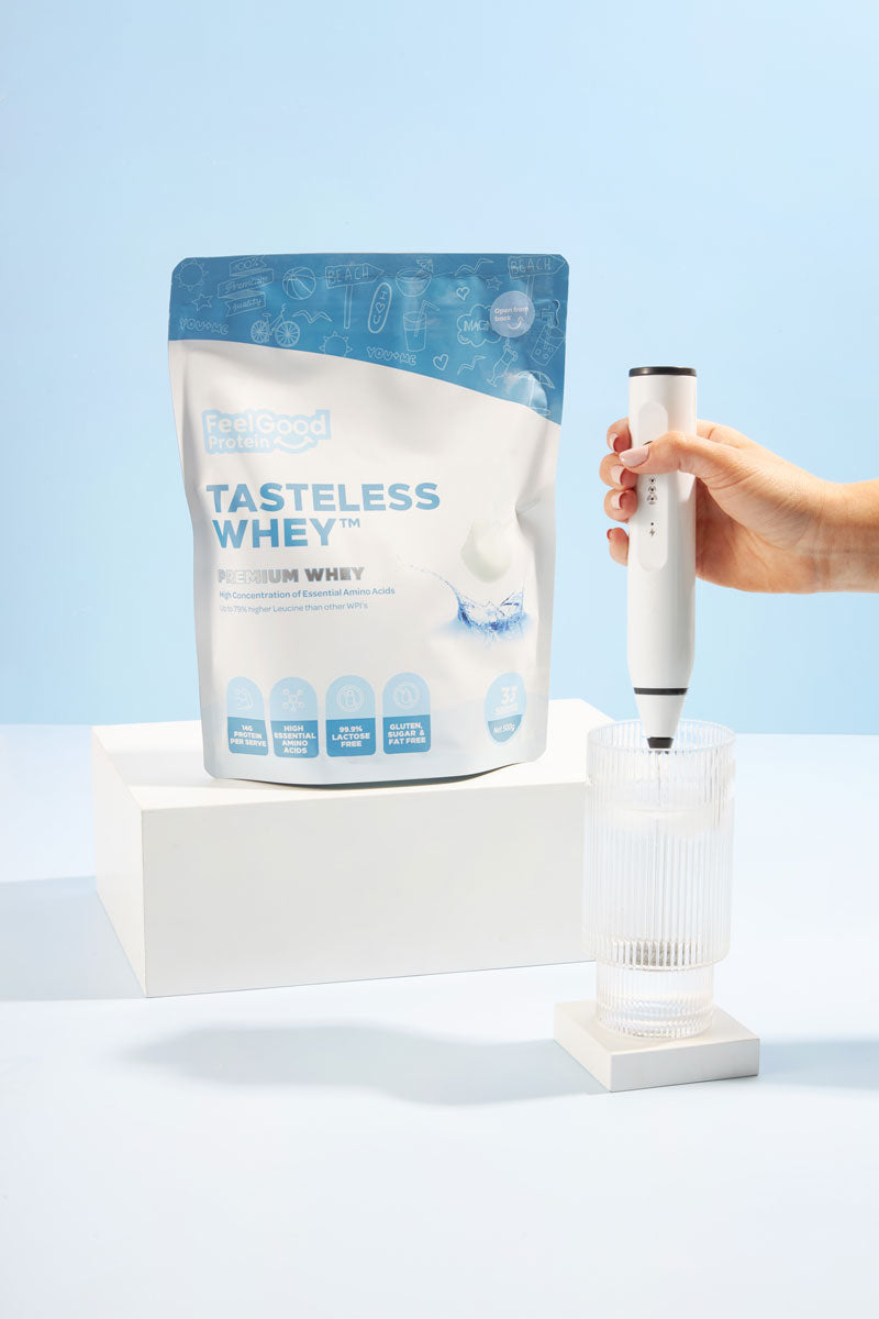 Tasteless Whey protein powder package with a hand holding a white scoop against a light blue background