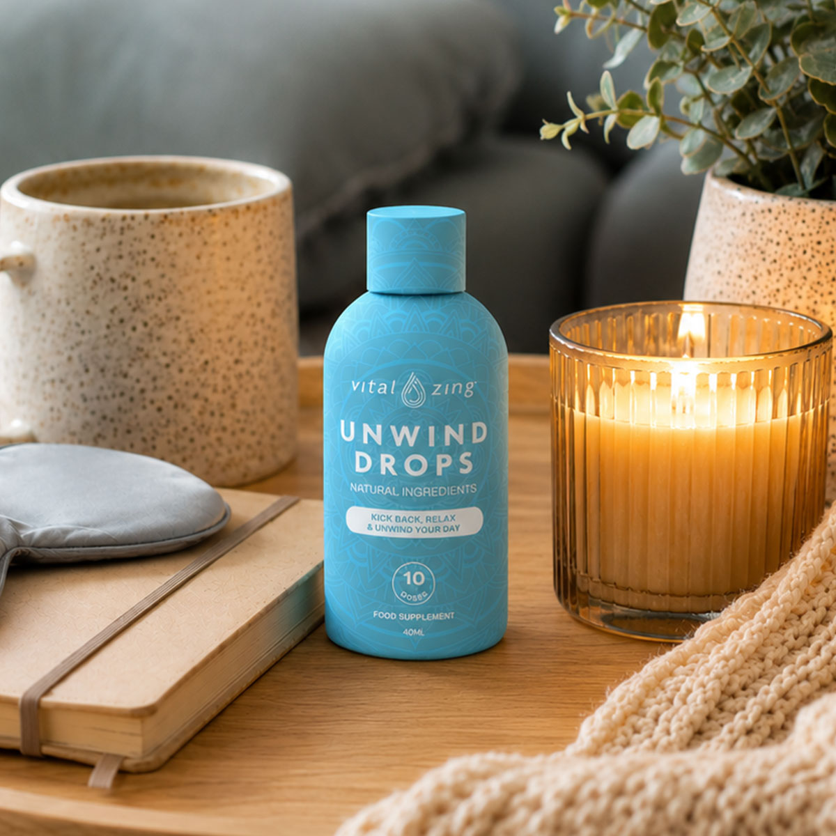 Vital Zing Unwind Drops 40ml in a relaxing setting with blanket, tea, book and eye mask