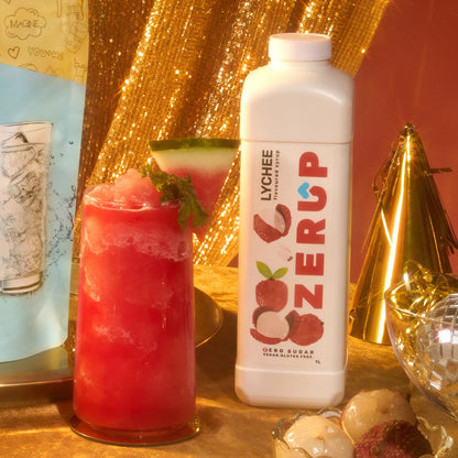 Lychee Sugar free syrup by Zerup on a party table next to a watermelon, lychee slushie