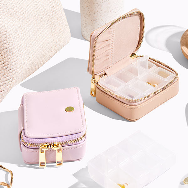 Vegan leather pill case with detachable, plastic pill container available in multiple colours.